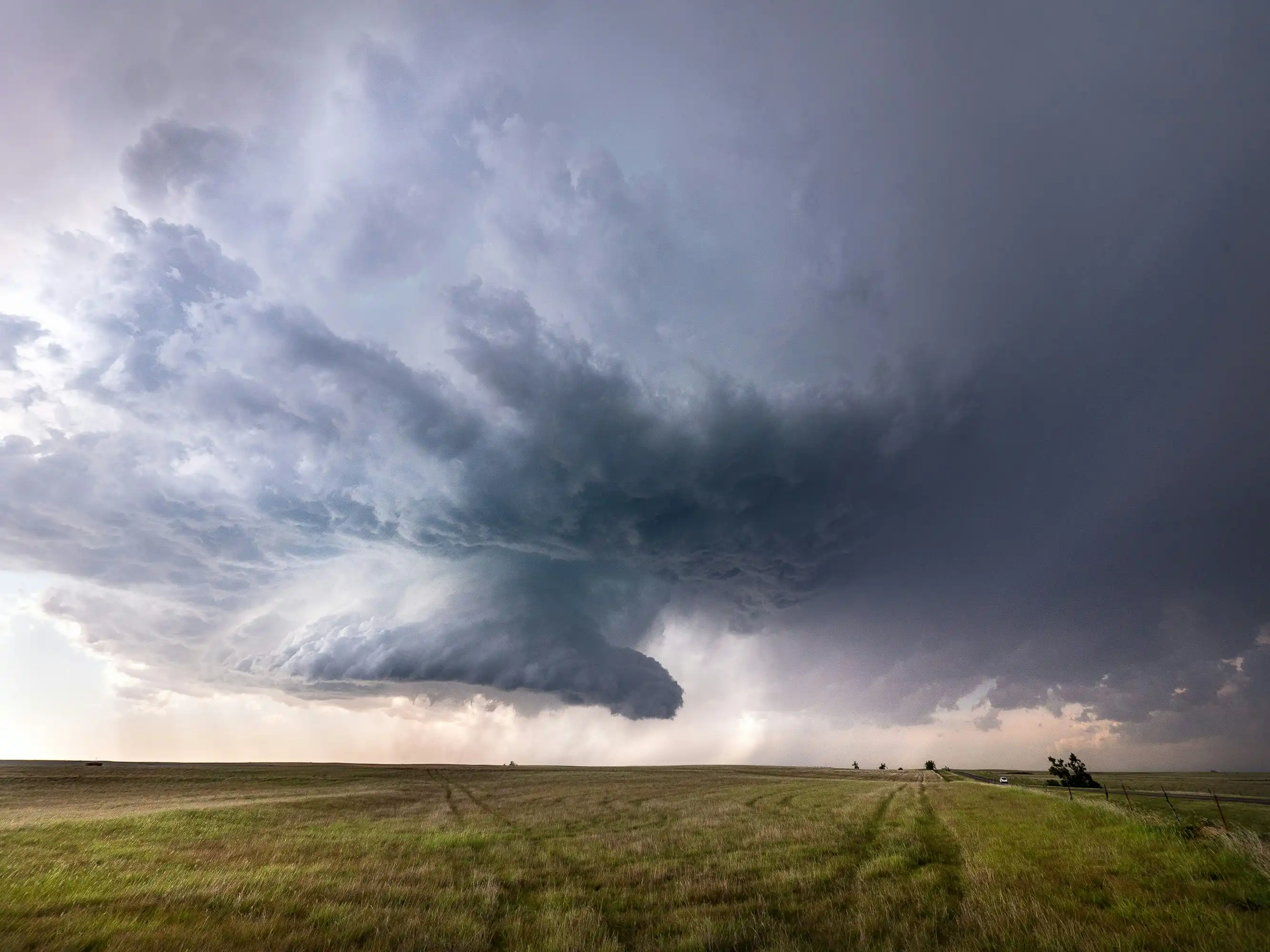 Photo of a dark thunderhead gathering over a field