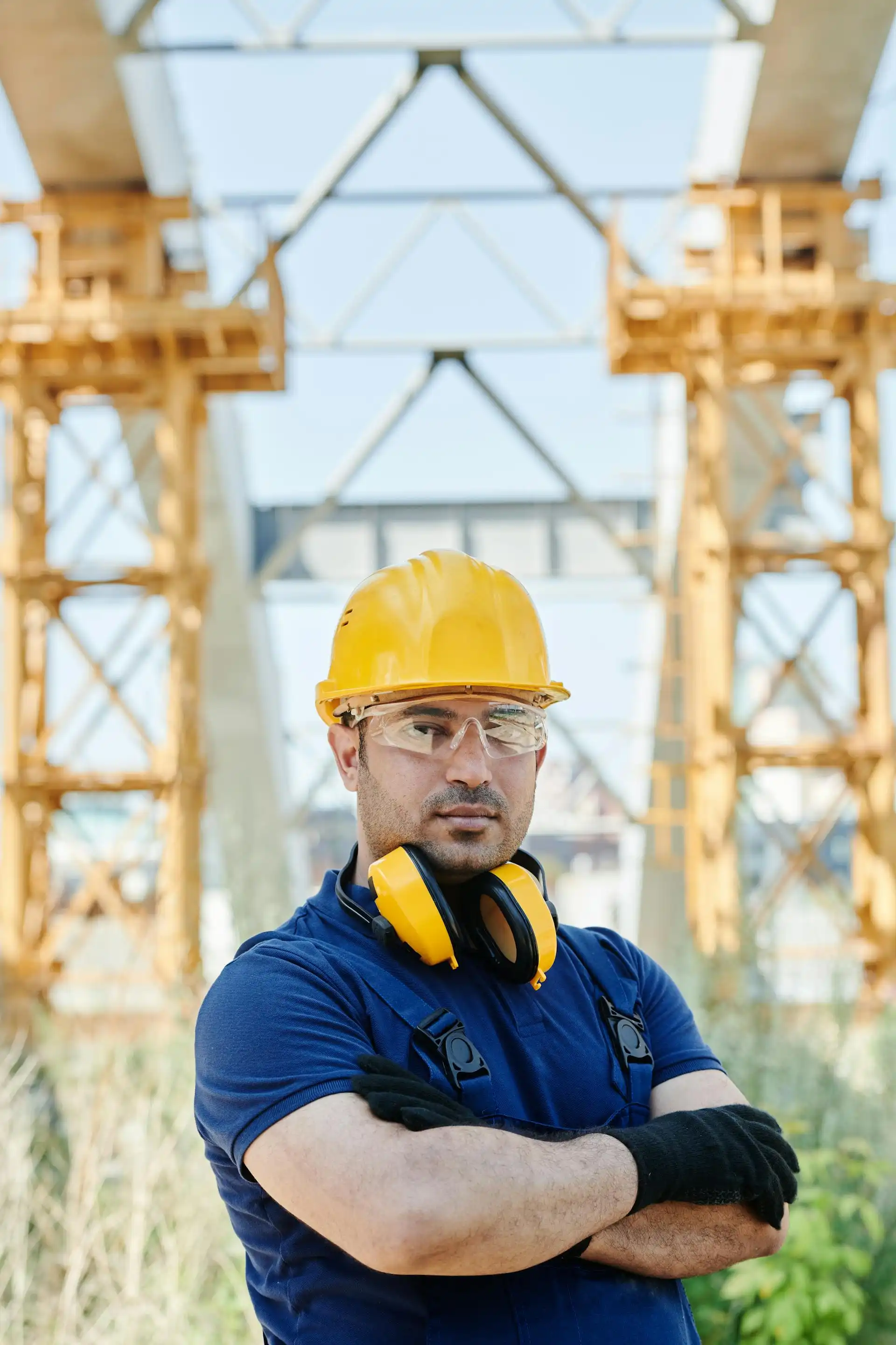 Man wearing head, eye and ear protection at an outdoor industrial site