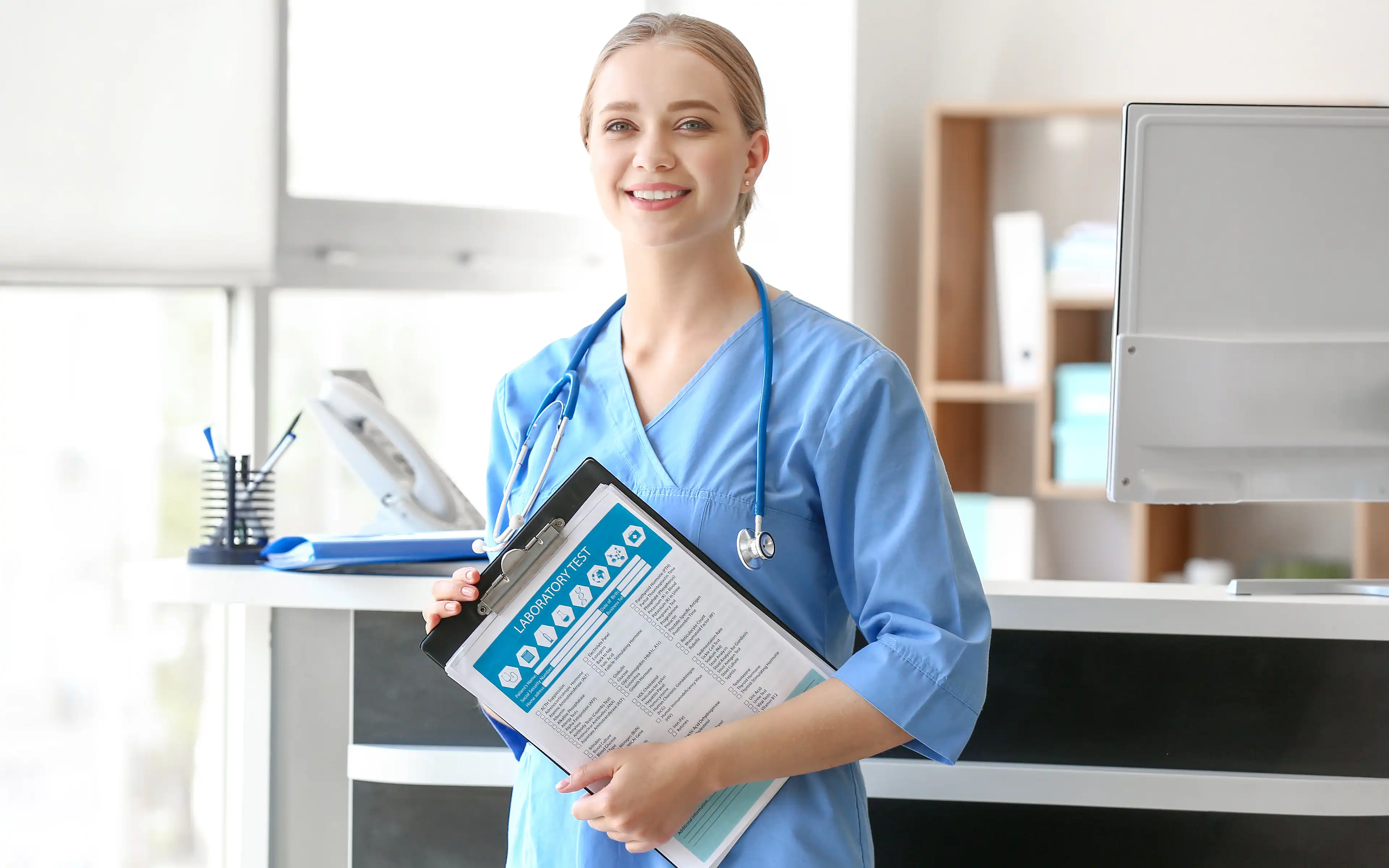 Woman in Blue Scrubs with Stethoscope and Clipboard